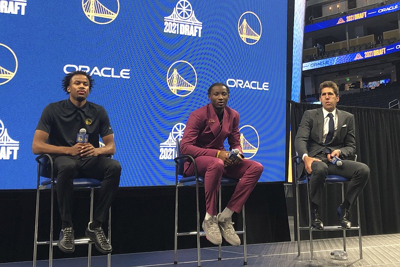 Former Arkansas guard Moses Moody (left), who was taken by the Golden State Warriors in the first round of Thursday night’s NBA Draft, takes part in a news conference with his new team Friday in San Francisco. Moody was joined at the news conference by fellow Warriors draftee Jonathan Kuminga and Golden State General Manager Bob Myers,
(AP/Janie McCauley)