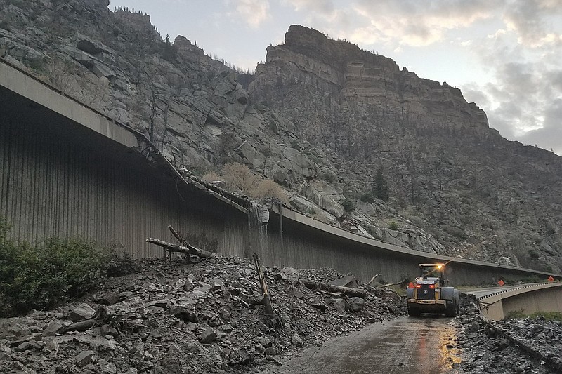 Crews and equipment work Friday to clear mud and debris on Interstate 70 through Glenwood Canyon, Colo., after rains triggered landslides.
(AP/Colorado Department of Transportation)