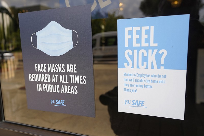 Face mask requirements are posted at the various entrances at the Rose E. McCoy Auditorium where COVID-19 vaccinations are being offered on the Jackson State University campus in Jackson, Miss., Tuesday, July 27, 2021. The university has similar signage posted throughout the campus. The Centers for Disease Control and Prevention announced new recommendations that vaccinated people return to wearing masks indoors in parts of the U.S. where the coronavirus is surging and also recommended indoor masks for all teachers, staff, students and visitors to schools, regardless of vaccination status. (The Associated Press)
