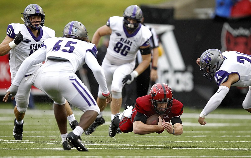 Arkansas State quarterback Layne Hatcher (3) dives for extra yardage between Central Arkansas linebackers Dre Matthews (45) and Darin Davenport (24) during the second quarter of the Red Wolves' 50-27 win on Saturday, Oct. 10, 2020, at Centennial Bank Stadium in Jonesboro. More photos at www.arkansasonline.com/1011asuuca/.(Arkansas Democrat-Gazette/Thomas Metthe)