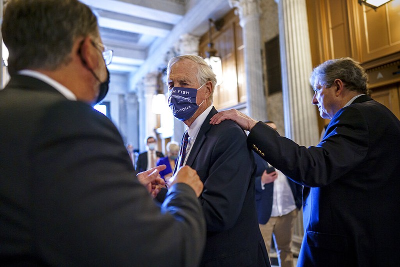 Sen. Angus King, I-Maine, center, speaks with Sen. Gary Peters, D-Mich., left, while Sen. John Kennedy, R-La., walks by at right, as the Senate votes to formally begin debate on a roughly $1 trillion infrastructure plan, a process that could take several days, at the Capitol in Washington, Friday, July 30, 2021. (AP/J. Scott Applewhite)