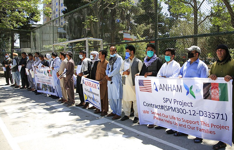 Former workers who had been employed with U.S. troops at the Bagram airbase hold placards during a demonstration against the U.S. government in Kabul, Afghanistan, Friday, July, 9, 2021. (AP/Mariam Zuhaib)
