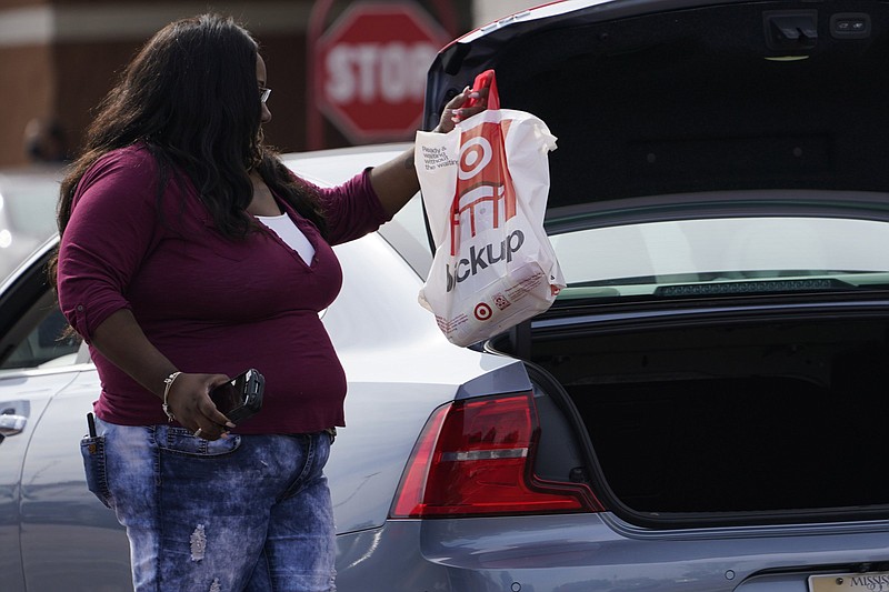 A Target employee places a curbside pickup purchase  in a trunk in Jackson, Miss., last year. Target Corp. said that it doesn’t want cost to be a barrier to higher education for its employees. Video at  arkansasonline.com/85target/
(AP)