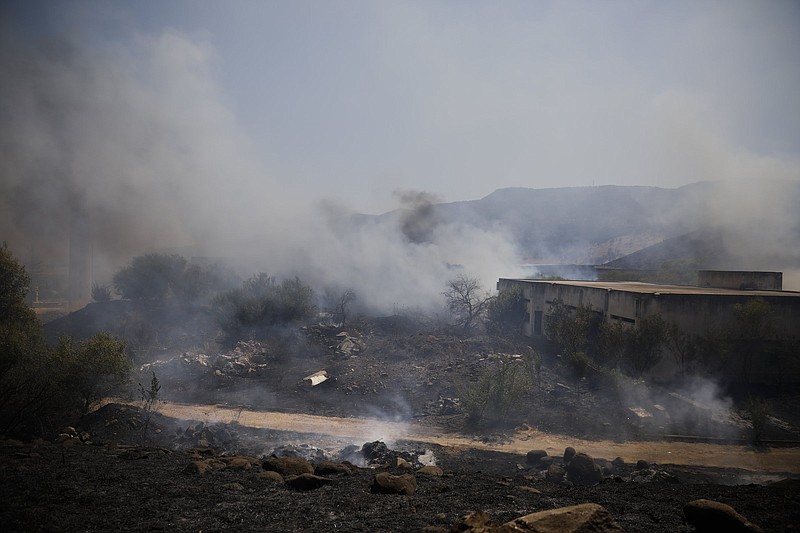 Fields burn Wednesday near the northern Israeli town of Kiryat Shmona after a hit by a rocket fired from Lebanon.
(AP/Ariel Schalit)