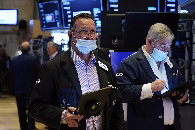 Trader Edward Curran (left) works on the floor of the New York Stock Exchange on Thursday.
(AP/Richard Drew)