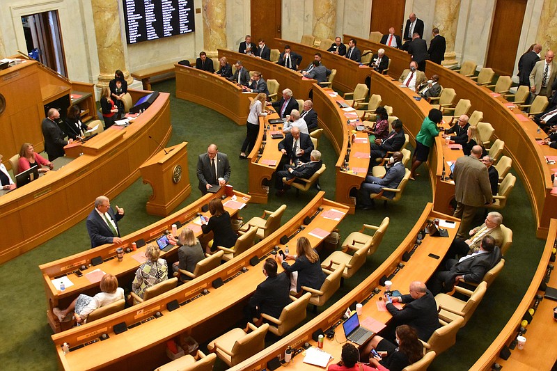 House members confer Thursday at the end of the day’s action. The House, voting mostly along party lines, joined the Senate in approving bills opposing supplemental federal unemployment benefits.
(Arkansas Democrat-Gazette/Staci Vandagriff)