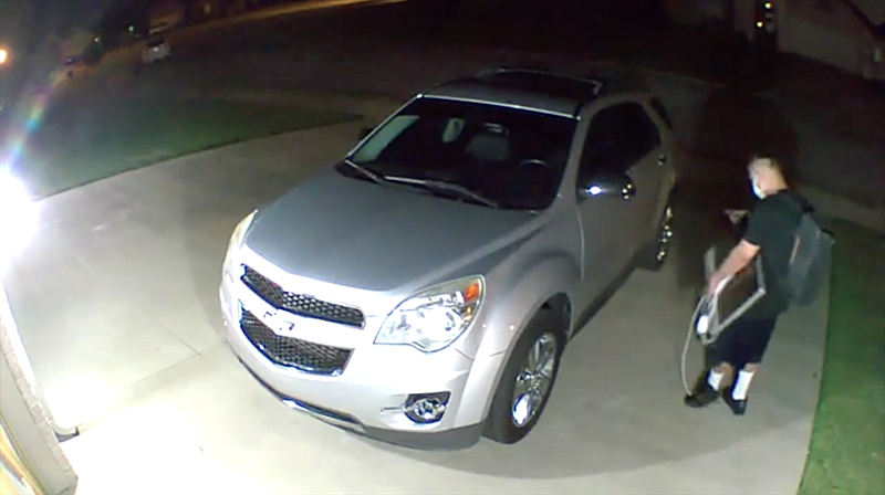 In this screenshot of video taken by a security camera, an unmarked Benton County Sheriff's Office vehicle is shown being stolen.