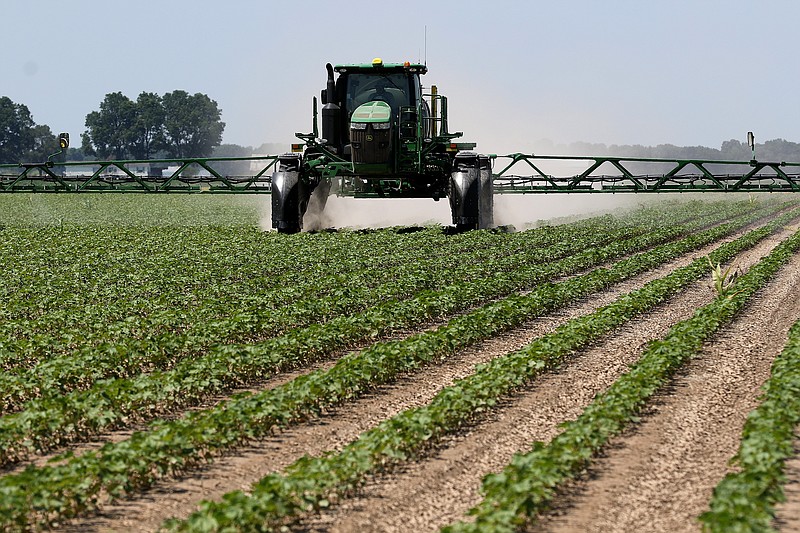 FILE -- A tractor sprays insecticide on a cotton field on Friday, June 18, 2021, at Brantley Farming Company in England.
(Arkansas Democrat-Gazette/Thomas Metthe)