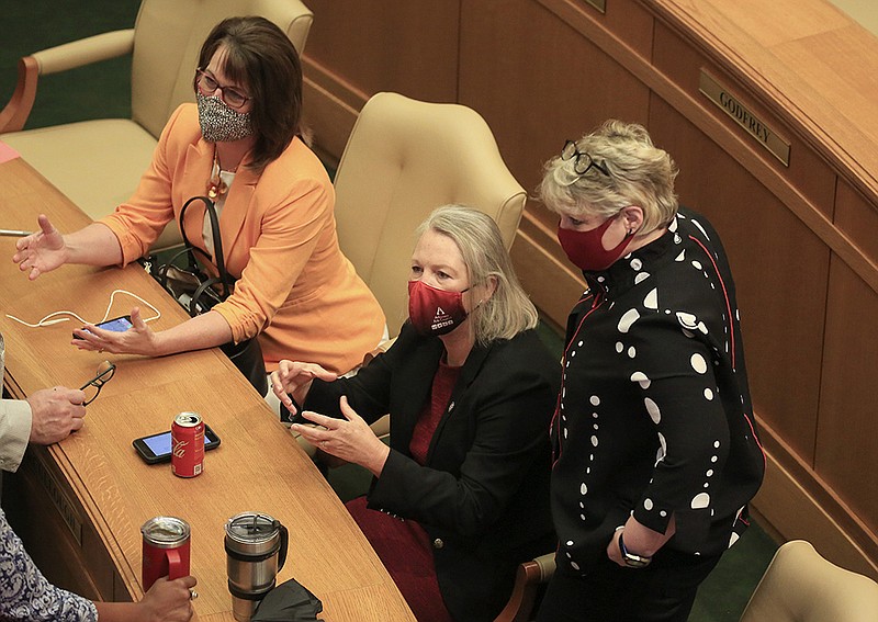State Reps. Julie Mayberry (from left), R-Hensley; Tippi McCullough, D-Little Rock; and Denise Garner, D-Fayetteville, talk Friday at the state Capitol after the House adjourned, ending the special session. Bills by the three legislators to relax the ban on mask mandates failed during the session. More photos at arkansasonline.com/87session/.
(Arkansas Democrat-Gazette/Staton Breidenthal)