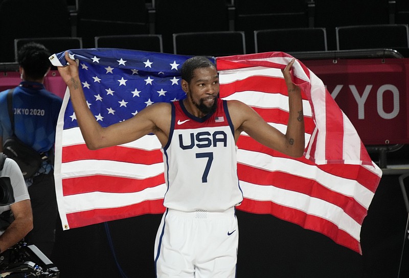 Kevin Durant celebrates after leading the United States to a victory over France in the Olympic men’s basketball gold medal game today at Saitama, Japan. The Americans have 16 gold medals in 19 attempts in men’s basketball. More photos available at arkansasonline.com/87tokyoball.
(AP/Luca Bruno)