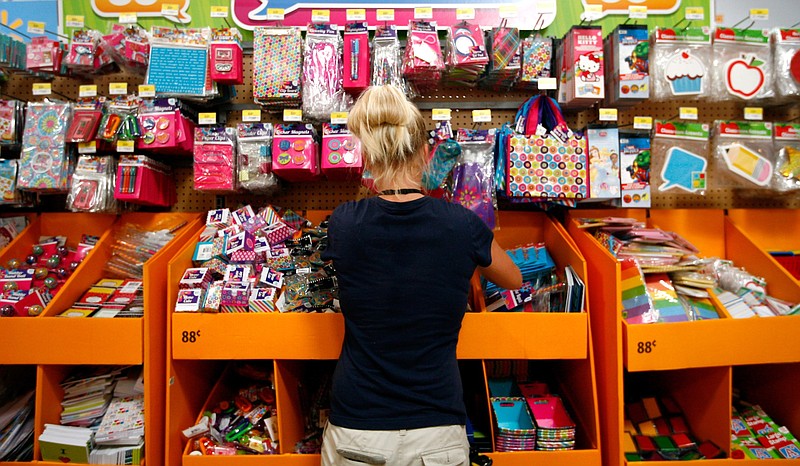 Walmart associate Amanda Sherrets organizes products in the back-to-school section inside the Supercenter on Mall Avenue in Fayetteville in this July 2012 file photo. (Arkansas Democrat-Gazette file photo)