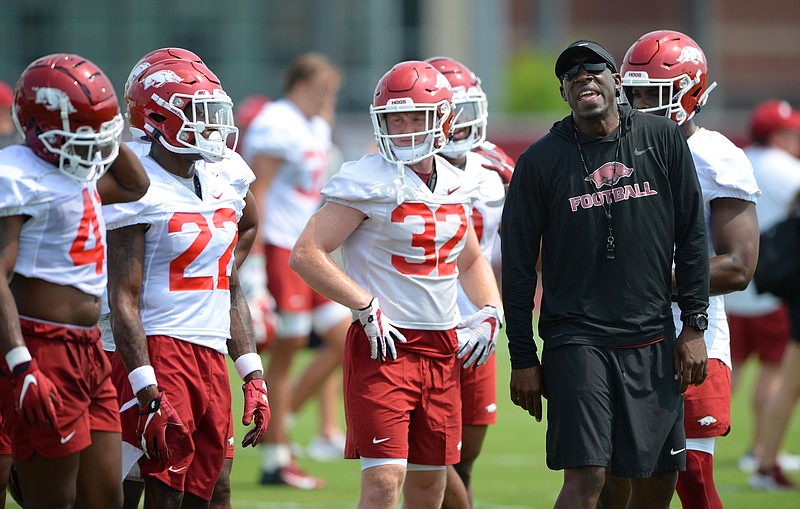 Arkansas assistant coach Jimmy Smith encourages his players Friday, Aug. 6, 2021, during practice at the university practice facility in Fayetteville. (NWA Democrat-Gazette/Andy Shupe)