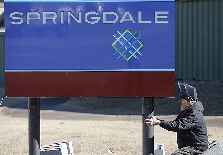 Lew Indorf, with Ken's Signs, installs Monday, February 22, 2021, a new city of Springdale city limits sign on So. Thompson Street in Springdale. (NWA Democrat-Gazette/David Gottschalk)