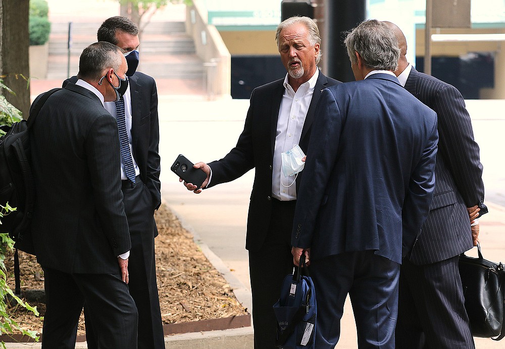 Marion School Superintendent Glen Fenter (center) talks Friday with attorney Tom Mars (left) outside the Pulaski County Courthouse in Little Rock. Circuit Judge Tim Fox granted a preliminary injunction blocking the state from enforcing the mask mandate ban.
(Arkansas Democrat-Gazette/Thomas Metthe)