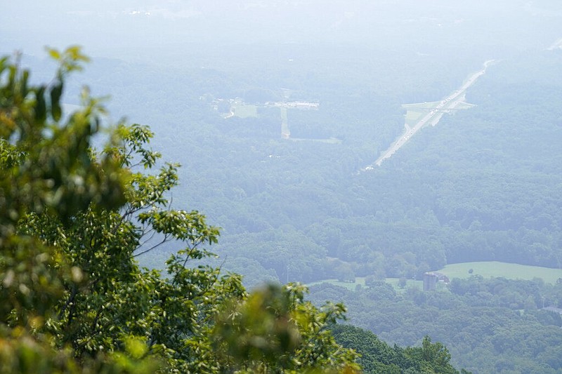 A smoky haze from western wildfires shrouds the valley and U.S. 52 below Pilot Mountain State Park, N.C., in this July 22, 2021, file photo. Hazy air has been reported across the country because of wildfires on the West Coast. (AP/Gerry Broome)