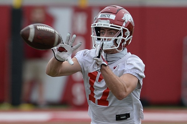Arkansas receiver John David White makes a catch Thursday, April 15, 2021, during practice at the university practice field in Fayetteville.