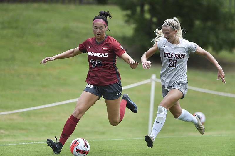 Arkansas forward McKenna Saul (88) leads the ball as Little Rock defender Bergros Asgeirsdottir (20) covers, Sunday, August 8, 2021 during a soccer scrimmage at Razorback Field in Fayetteville. Check out nwaonline.com/210809Daily/ for today's photo gallery. .(NWA Democrat-Gazette/Charlie Kaijo)