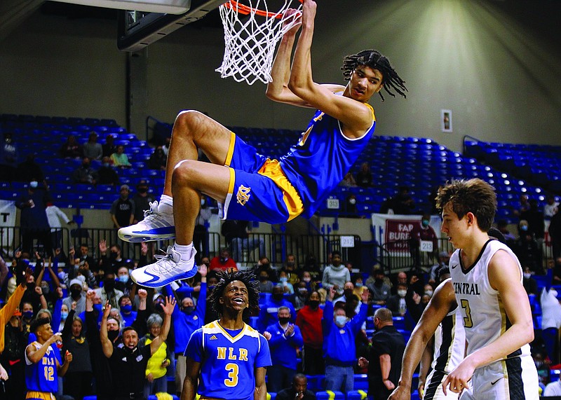 North Little Rock's Kel'el Ware (10) hangs on the rim after a dunk during the fourth quarter of the Charging Wildcats' 65-55 win in the Class 6A boys state championship game on Thursday, March 18, 2021, at Bank OZK Arena in Hot Springs. .More photos at www.arkansasonline.com/319boys6a/.(Arkansas Democrat-Gazette/Thomas Metthe)