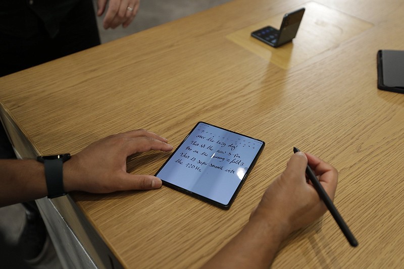 The compatibility of the S Pen Pro with the Samsung Galaxy Fold 3 is demonstrated Monday at Samsung KX in London. Samsung hopes to make the foldable concept more appealing with its new lineup.
(AP/Tristan Werkmeister)