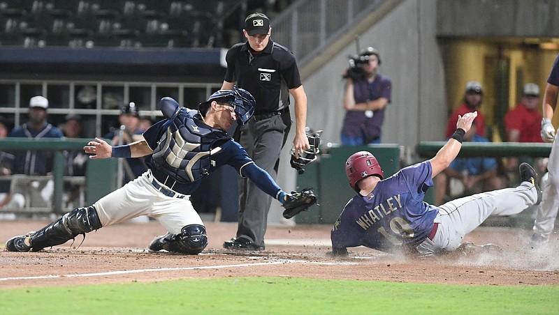 FILE — Frisco’s Matt Whatley (right) slides into home plate in front of a tag attempt by Northwest Arkansas catcher Freddy Fermin during the fifth inning of the RoughRiders’ 3-2 victory over the Naturals at Arvest Ballpark in Springdale in this Aug. 12, 2021 file photo. More photos at nwaonline.com/21000813Daily/.
(NWA Democrat-Gazette/J.T. Wampler)