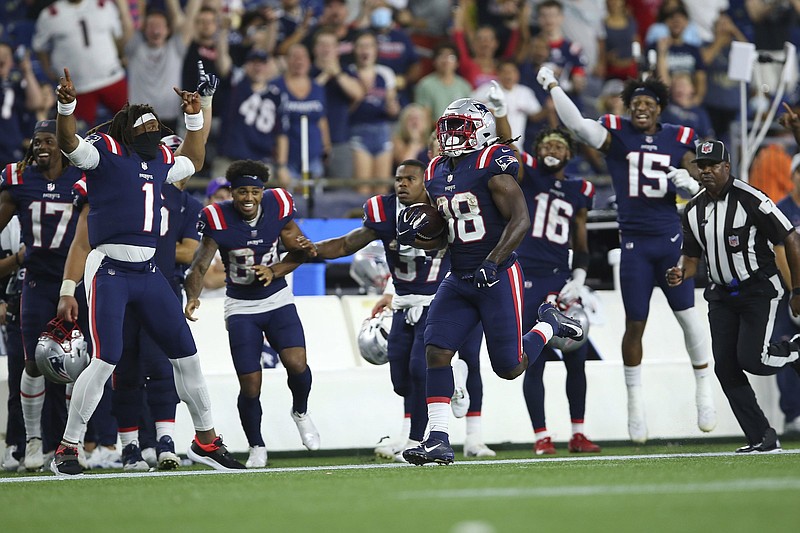 New England Patriots' Rhamondre Stevenson runs against the Detroit