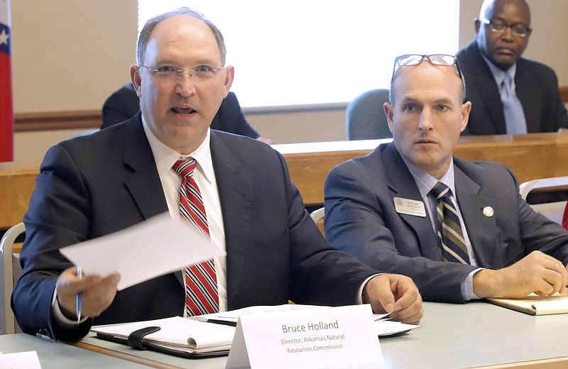 Bruce Holland (left), then the director of the Arkansas Natural Resources Commission, gives his commission's overview of levees in Arkansas to members of the Arkansas Levee Task Force as state geographic information coordinator Shelby Johnson looks on in this Aug. 1, 2019, file photo. (Arkansas Democrat-Gazette file photo)