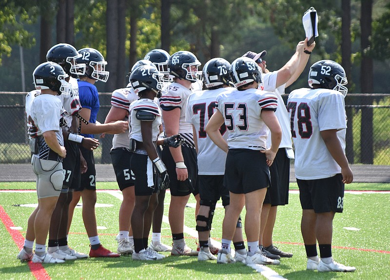 White Hall assistant head coach and offensive line coach Jason Mitchell shows a play to the offense during a practice Aug. 4. 
(Pine Bluff Commercial/I.C. Murrell)