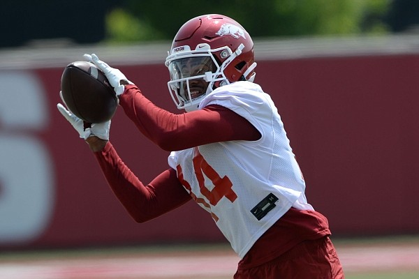 Arkansas receiver Bryce Stephens makes a catch Saturday, Aug. 7, 2021, during practice at the university practice facility in Fayetteville.