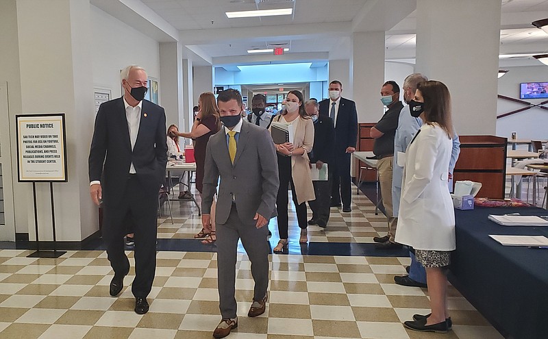 Photo by Bradly Gill
Arkansas Governor Asa Hutchinson walks with SAU Tech Chancellor Jason Morrison, while Dr. Jera Smith looks on, before a question and answer session hosted in the Grand Hall