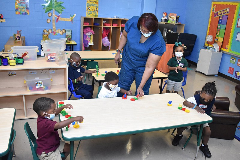 Carla Claggett, a prekindergarten teacher at Forrest Park/Greenville Preschool, observes as her students use their imaginations to make Lego block designs Wednesday on the first day of class. 
(Pine Bluff Commercial/I.C. Murrell)