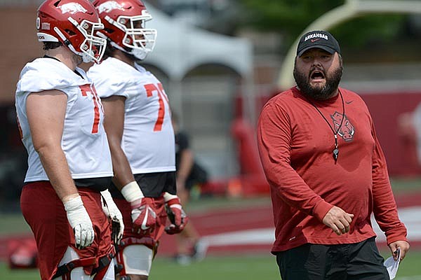 Arkansas assistant coach Cody Kennedy speaks to the offensive line Friday, Aug. 6, 2021, during practice in Fayetteville.