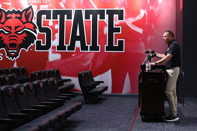 Arkansas State first-year Coach Butch Jones speaks from the podium during the Red Wolves’ media day activities Thursday at the Centennial Bank Athletics Operations Center in Jonesboro. “We’re building the best college football program in America,” Jones said.
(Arkansas Democrat-Gazette/Thomas Metthe)