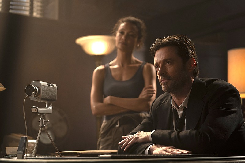 High-functioning alcoholic Watts (Thandiwe Newton) and her partner Nick Bannister (Hugh Jackman) investigate the disappearance of a client in the sci-fi femme fatale tale “Reminiscence.”