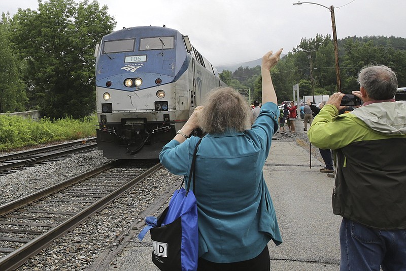 An onlooker waves as the Amtrak Vermonter passenger train arrives on July 19 at the Montpelier station, in Berlin, Vt. A celebration was held at Amtrak stations across Vermont to mark the return of the passenger trains to Vermont for the first time since they were suspended at the beginning of the covid-19 pandemic.
(AP/Wilson Ring)