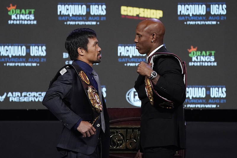 Manny Pacquiao (left) and Yordenis Ugas are scheduled to fight for the WBA welterweight title tonight in Las Vegas. It’s Pacquiao’s first fight after a two-year absence, the longest of his career.
(AP/John Locher)