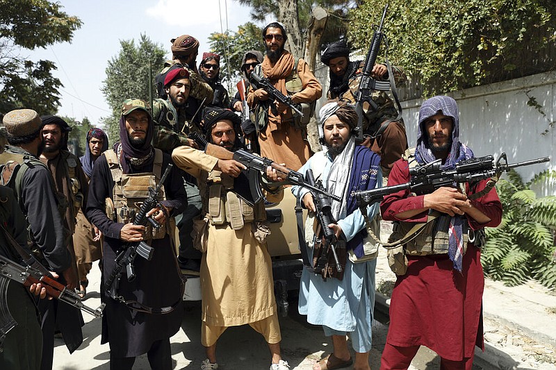 Taliban fighters pose for a photograph in Kabul, Afghanistan, Thursday, Aug. 19, 2021. (AP/Rahmat Gul)