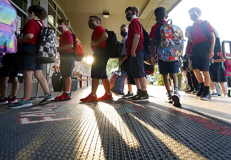 Wearing masks to prevent the spread of covid-19, elementary school students line up to enter school for the first day of classes in Richardson, Texas, Tuesday, Aug. 17, 2021. (AP/LM Otero)