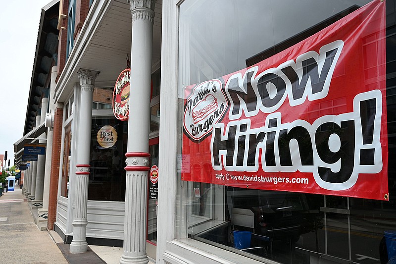 A sign Friday at David’s Burgers in Little Rock’s River Market District announces job openings while another sign says that the outlet is temporarily closed because of a shortage of workers.
(Arkansas Democrat-Gazette/Stephen Swofford)