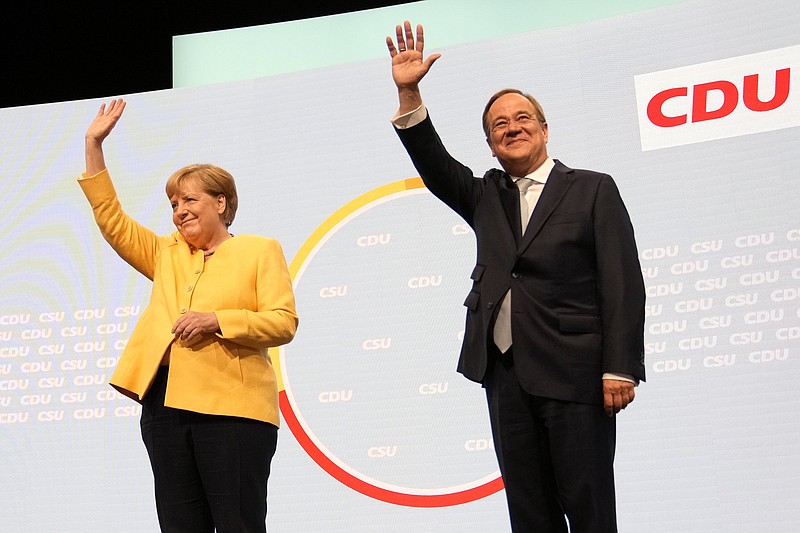Armin Laschet (right), the center-right Union bloc’s candidate for chancellor in Germany’s September election, and outgoing Chancellor Angela Merkel arrive Saturday for an event in Berlin kicking off the conservatives’ official election campaign.
(AP/Markus Schreiber)