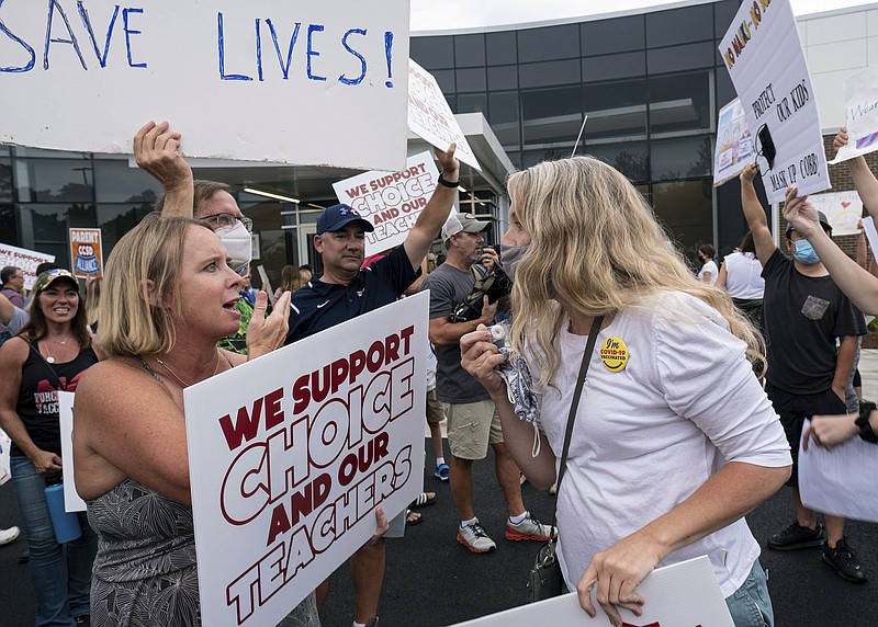 People on both sides of the mask mandate in schools issue in Cobb County, Ga., face off Thursday ahead of a school board meeting in Marietta, Ga. Similar confrontations are happening across the country over masks and vaccines. “The heat definitely got turned up this week,” said Shannon Portillo, a county commissioner in Kansas who was berated Wednesday at a meeting on masks. “It got much more hostile than anything I had seen.”
(AP/Atlanta Journal-Constitution/Ben Gray)