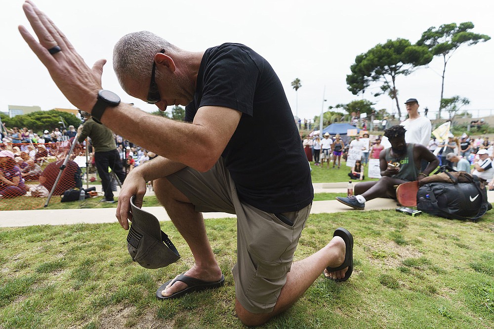 Steve Taylor, a U.S. Army chaplain, prays Saturday at a “S.O.S California No Vaccine Passport Rally” at Tongva Park in Santa Monica, Calif., protesting Los Angeles’ impending vaccine mandate.
(AP/Damian Dovarganes)