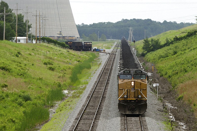 A locomotive pulling coal cars is stopped near the White Bluff power plant near Redfield in this June 2, 2014, file photo. (AP/Danny Johnston)