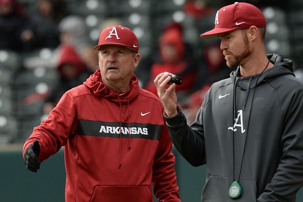 Arkansas coach Dave Van Horn speaks to pitching coach Matt Hobbs during the seventh inning of a Feb. 16, 2019, game against Eastern Illinois at Baum-Walker Stadium in Fayetteville.