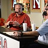 Arkansas football coach Sam Pittman (left) speaks with Chuck Barrett during "Sam Pittman Live" on Wednesday, Aug. 25, 2021, at Catfish Hole in Fayetteville.