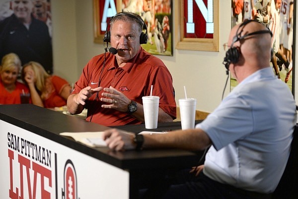 Arkansas football coach Sam Pittman (left) speaks with Chuck Barrett during "Sam Pittman Live" on Wednesday, Aug. 25, 2021, at Catfish Hole in Fayetteville.