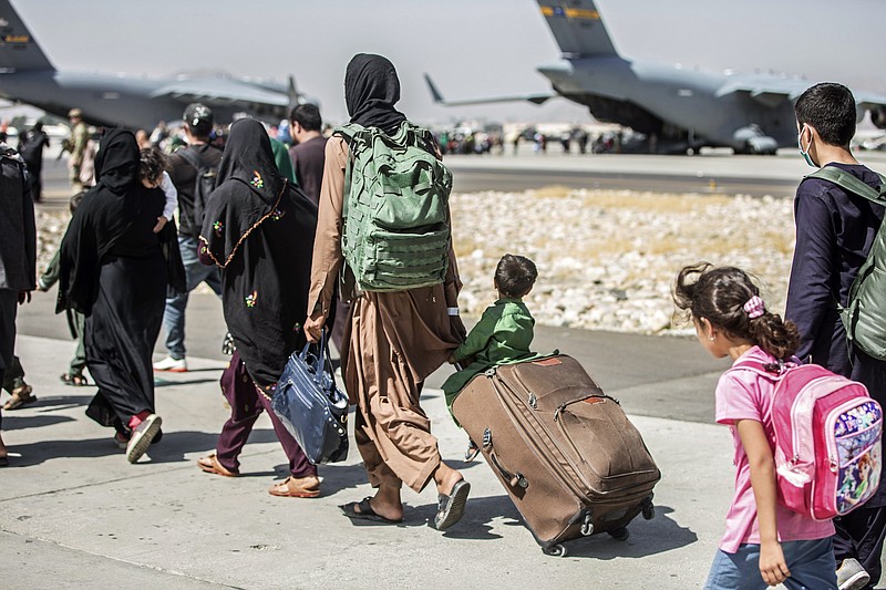 FILE - In this Aug. 24, 2021, file photo, provided by the U.S. Marine Corps, families walk towards their flight during ongoing evacuations at Hamid Karzai International Airport, in Kabul, Afghanistan.
(Sgt. Samuel Ruiz/U.S. Marine Corps via AP, File)