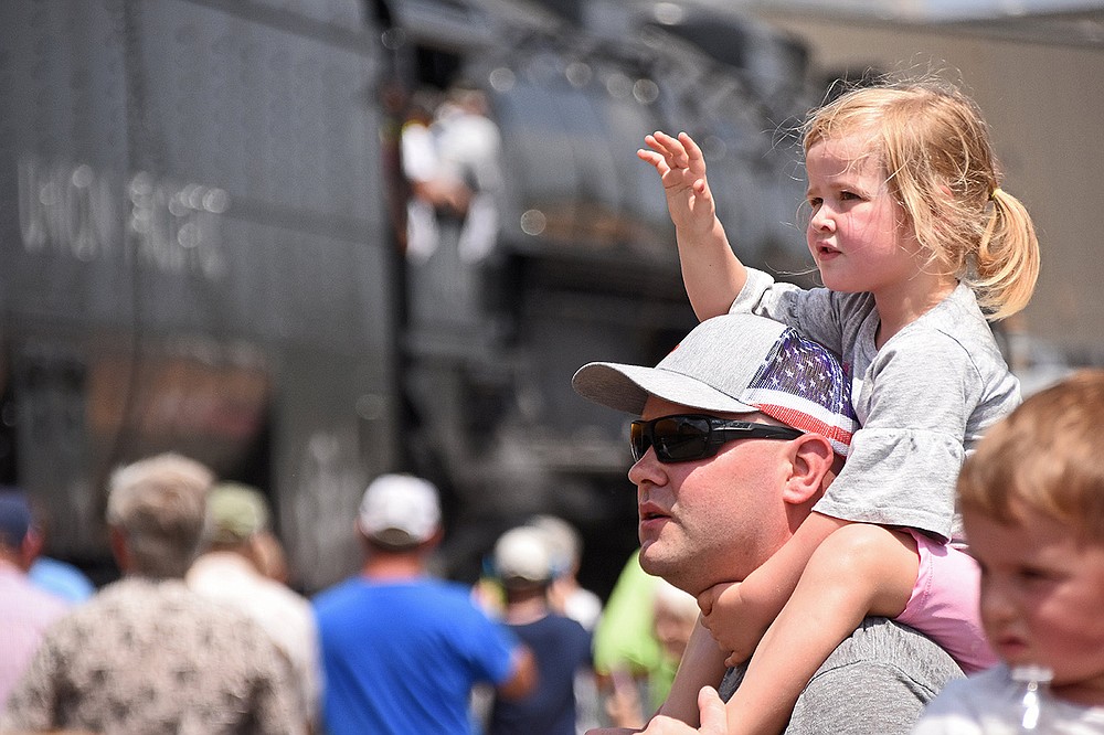 AnneMarie Ramage, 3, waves as she and her father, Daniel Ramage, watch the Union Pacific Big Boy steam locomotive No. 4014 roll to a stop Thursday at the Union Pacific facility in North Little Rock. More photos at arkansasonline.com/827steam/.
(Arkansas Democrat-Gazette/Staci Vandagriff)