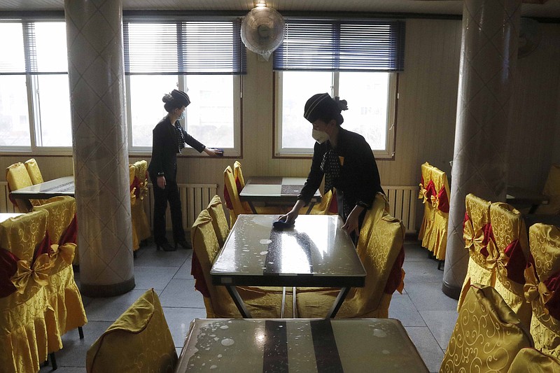 A February photo shows staffers at the Pongnam Noodle House disinfect the tables and windows of the restaurant in Pyongyang, North Korea.
(AP/Jon Chol Jin)