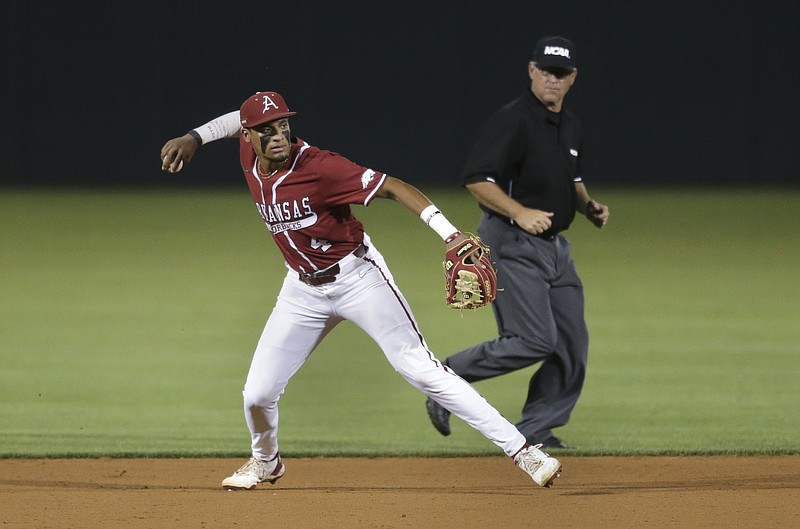 FILE -- Arkansas infielder Jalen Battles (4) throws to first, Saturday, June 5, 2021 during the eighth inning in the second game of the NCAA Fayetteville Regional at Baum-Walker Stadium in Fayetteville. 
(NWA Democrat-Gazette/Charlie Kaijo)