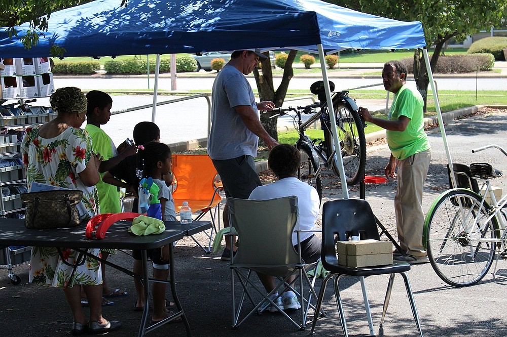 Sandra and Kenneth Fisher, shown with their bike shop stand during 2018’s Second Saturday Family FunDay, will take part in the Arts & Science Center’s Tinkerfest Sept. 18.
(Special to The Commercial)